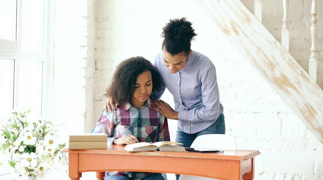 person reading book at desk